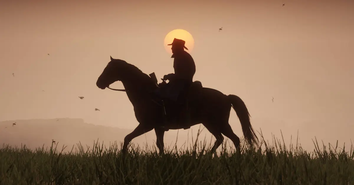Arthur Morgan à cheval pendant un coucher de soleil dans Red Dead Redemption 2.